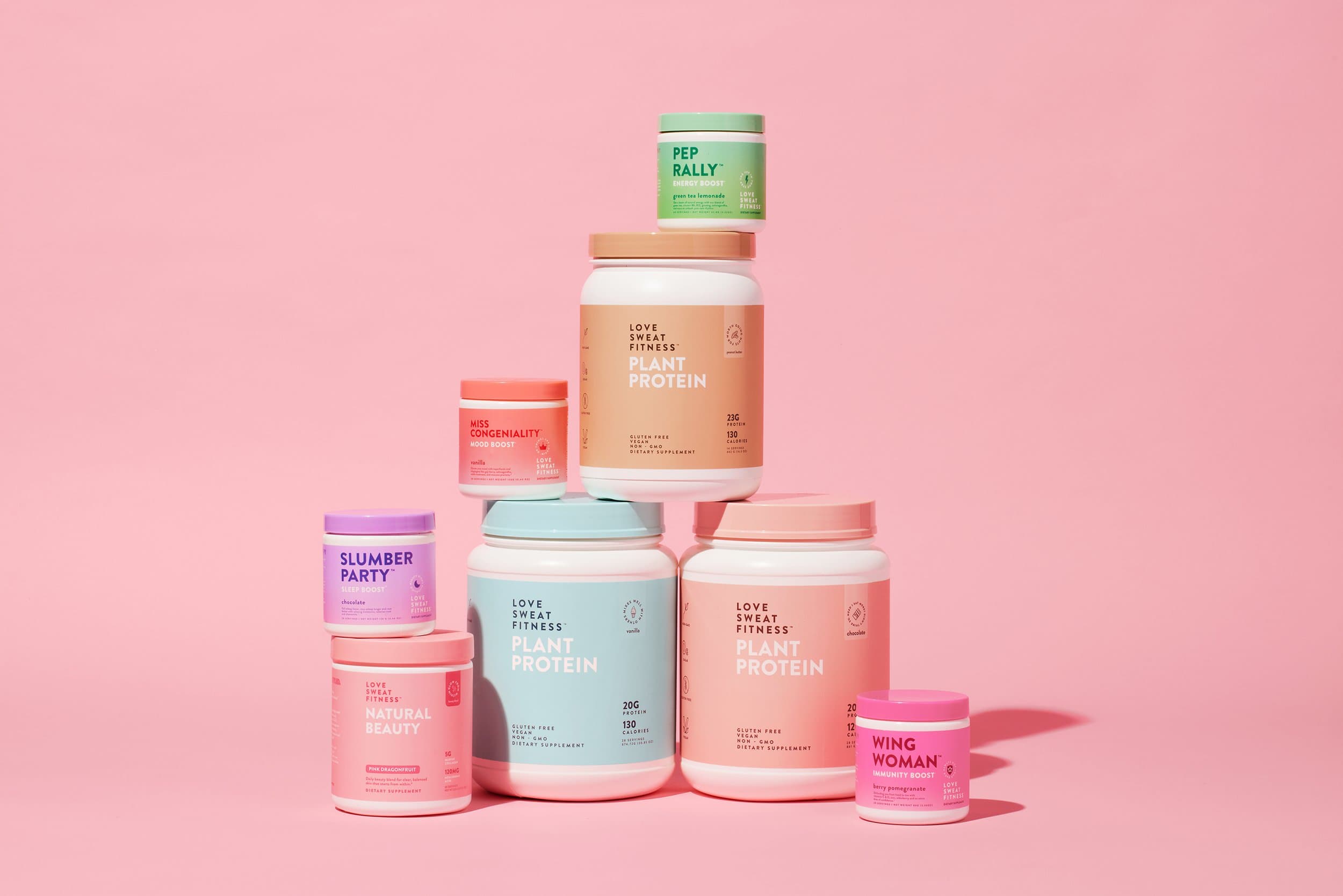 A series of Love Sweat Fitness multi-coloured supplements on pink