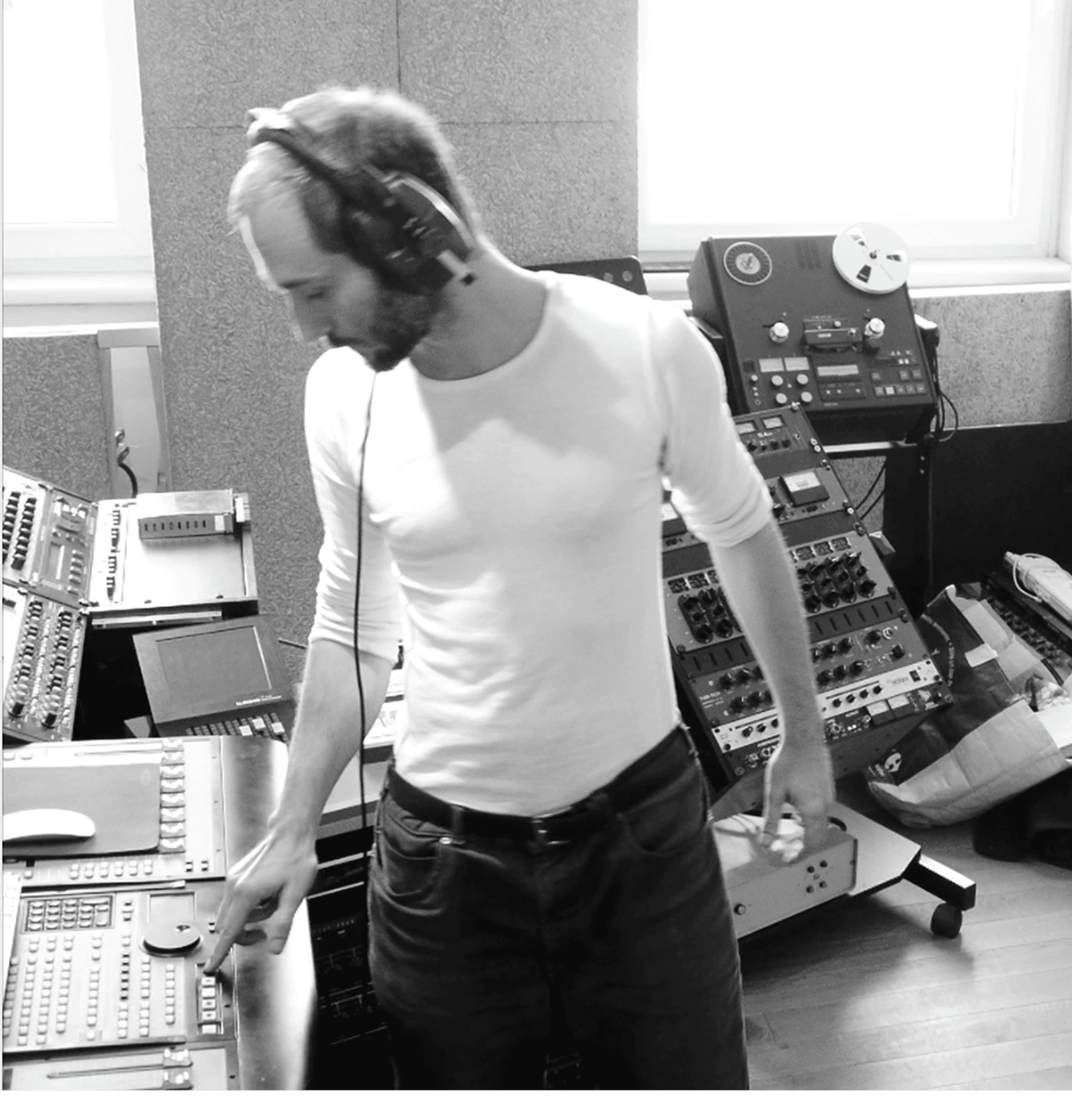 a musician in black and white works in his studio